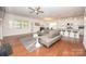 Open-concept living room flowing into the kitchen with hardwood floors and a stylish gray sofa at 529 Cellini Pl # 243, Mount Holly, NC 28120