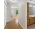 Hallway leading to bathroom with wooden vanity, sink, and a bedroom with a window at 534 Donatello Ave, Charlotte, NC 28205