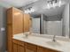 Bathroom featuring double sinks, a wooden vanity, large mirror, cabinets, and shower with tub at 534 Donatello Ave, Charlotte, NC 28205
