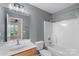 Gray bathroom featuring a shower-tub combo, a modern vanity, and a mirrored wall cabinet at 534 Donatello Ave, Charlotte, NC 28205