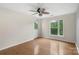 Bedroom with light walls, hardwood floors, a ceiling fan, and a white door to the outside at 534 Donatello Ave, Charlotte, NC 28205