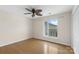 Bedroom with hardwood floors, a ceiling fan, a window, light walls, and base molding at 534 Donatello Ave, Charlotte, NC 28205
