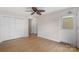 Bedroom with hardwood floors, white walls, closets, and a white door to the outside at 534 Donatello Ave, Charlotte, NC 28205
