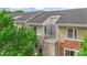 Exterior view of the home with neutral siding, brick accents, and a private balcony at 534 Donatello Ave, Charlotte, NC 28205
