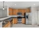 Well-lit kitchen featuring stainless steel appliances, wooden cabinets, and gray countertops at 534 Donatello Ave, Charlotte, NC 28205