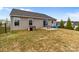 Backyard with a patio area featuring outdoor seating, a dog house, and plenty of green space at 550 Cherry Blossom Nw Ave, Concord, NC 28027