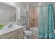 Cozy bathroom featuring tile floors, tile shower, tub, and single sink vanity at 550 Cherry Blossom Nw Ave, Concord, NC 28027
