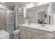 Bathroom with a double sink vanity, large mirror, and walk-in shower at 550 Cherry Blossom Nw Ave, Concord, NC 28027