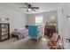 bedroom featuring carpet floors, a ceiling fan, and a crib at 550 Cherry Blossom Nw Ave, Concord, NC 28027