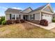 Attractive home with stone accents, dark shutters, and a well-manicured lawn and walkway at 550 Cherry Blossom Nw Ave, Concord, NC 28027