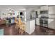 Modern kitchen with stainless steel appliances and granite countertops opens to the living room at 550 Cherry Blossom Nw Ave, Concord, NC 28027