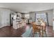 Open eat-in kitchen with stainless steel appliances, a kitchen island, and dining table at 550 Cherry Blossom Nw Ave, Concord, NC 28027