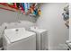 Laundry room featuring a washer, dryer, and storage shelves at 550 Cherry Blossom Nw Ave, Concord, NC 28027