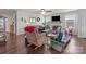Cozy living room with hardwood floors, fireplace, ceiling fan and lots of natural light at 550 Cherry Blossom Nw Ave, Concord, NC 28027