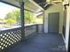Cozy outdoor balcony featuring grey accents, railings and a ceiling fan at 5810 Harris Grove Ln, Charlotte, NC 28212