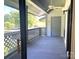 View of outdoor balcony with ceiling fan, grey storage door, and lattice railings at 5810 Harris Grove Ln, Charlotte, NC 28212