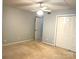 Bedroom includes carpet, neutral paint, and double door closet at 5810 Harris Grove Ln, Charlotte, NC 28212