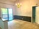 Bright dining area with a decorative chandelier, wainscoting, and sliding glass doors to the outside at 5810 Harris Grove Ln, Charlotte, NC 28212