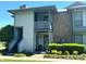 Charming condo exterior featuring a private entrance, balcony, and well-manicured landscaping at 5810 Harris Grove Ln, Charlotte, NC 28212