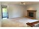 Open living room with a brick fireplace, access to a balcony, neutral carpeting, and a ceiling fan at 5810 Harris Grove Ln, Charlotte, NC 28212