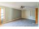 A light and bright bedroom with wood floors and a ceiling fan at 5944 Freedom Dr, Charlotte, NC 28214
