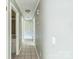 Long hallway with tile floor and a view to a room at the end at 5944 Freedom Dr, Charlotte, NC 28214