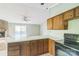 Cozy kitchen with an open concept, featuring a stone fireplace, an open view to the backyard, and classic appliances at 5944 Freedom Dr, Charlotte, NC 28214