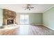 A spacious living room featuring a stone fireplace and sliding glass doors to the backyard at 5944 Freedom Dr, Charlotte, NC 28214