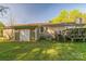 Back exterior featuring access door, small deck, and green lawn, ideal for outdoor activities and gatherings at 5944 Freedom Dr, Charlotte, NC 28214