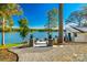 Picturesque backyard overlooking a tranquil lake, enhanced by stone pillars and manicured grounds at 6788 Bucleigh Rd, Clover, SC 29710