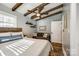Bedroom featuring exposed wood beams, a ceiling fan, and cozy furnishings, creating a warm ambiance at 6788 Bucleigh Rd, Clover, SC 29710