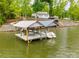 Lake Norman waterfront property with a boat dock featuring covered slips for two boats at 6788 Bucleigh Rd, Clover, SC 29710