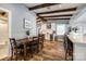 Open-concept layout with a dining area flowing into a modern kitchen and adjacent bar seating at 6788 Bucleigh Rd, Clover, SC 29710