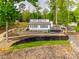 Modern lakefront home with a metal roof, a deck, and tiered landscaping at 6788 Bucleigh Rd, Clover, SC 29710