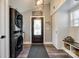 Inviting mudroom with stackable laundry, storage cabinets, and stylish decor with a wood front door at 6788 Bucleigh Rd, Clover, SC 29710