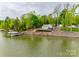 Charming waterfront home nestled among mature trees, featuring a private dock and stunning lake views at 6788 Bucleigh Rd, Clover, SC 29710