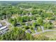 An aerial view exhibits a neighborhood with tree-lined streets, and well-spaced homes in a green environment at 692 S Pink St, Cherryville, NC 28021