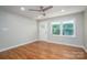 Modern bedroom with hardwood floors, neutral paint, large windows, and a contemporary ceiling fan at 692 S Pink St, Cherryville, NC 28021