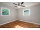 This bright bedroom has hardwood floors, two windows, and neutral walls at 692 S Pink St, Cherryville, NC 28021