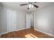 Cozy bedroom with hardwood floors, neutral paint, ceiling fan, and ample closet space for storage at 692 S Pink St, Cherryville, NC 28021