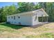 Rear view of gray brick home with covered porch and green lawn at 692 S Pink St, Cherryville, NC 28021
