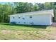 Rear view of gray brick home with well maintained green lawn at 692 S Pink St, Cherryville, NC 28021