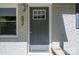 Close up view of the front door with house number, window and gray painted brick facade at 692 S Pink St, Cherryville, NC 28021