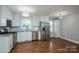 Modern kitchen featuring stainless steel appliances, white cabinetry, granite countertops, and hardwood floors at 692 S Pink St, Cherryville, NC 28021