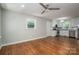 Spacious living room with hardwood floors, neutral walls, ceiling fan, and seamlessly connects to the kitchen at 692 S Pink St, Cherryville, NC 28021
