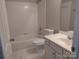 Clean bathroom featuring a shower-tub combo, tile flooring, and a white vanity at 7731 Harrington Woods Rd # 17, Charlotte, NC 28269