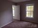 Comfortable bedroom with soft carpet, bright windows, and ample natural light at 7731 Harrington Woods Rd # 17, Charlotte, NC 28269