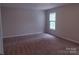 Cozy bedroom featuring plush carpeting, a window with natural light, and neutral walls at 7731 Harrington Woods Rd # 17, Charlotte, NC 28269
