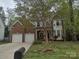 Charming two-story home with a brick facade and well-manicured lawn offers great curb appeal at 7731 Harrington Woods Rd # 17, Charlotte, NC 28269