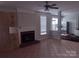Spacious living room featuring a brick fireplace, tile flooring, and abundant natural light at 7731 Harrington Woods Rd # 17, Charlotte, NC 28269